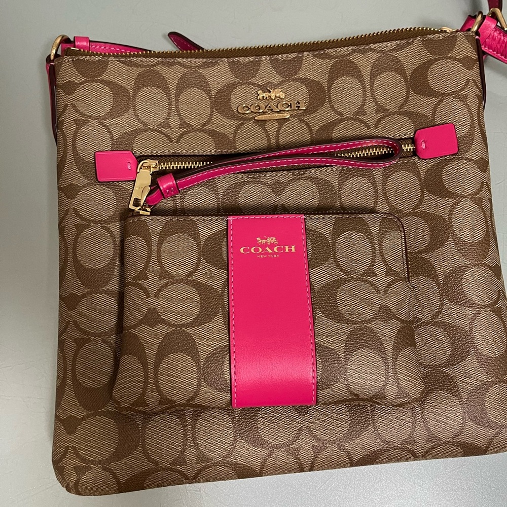 Coach Rowan File crossbody and coin purse with pink details.